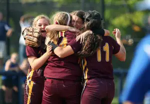 HUG TIME — Abbey Bauer, with back to camera in middle, is mobbed by teammates, from left, Emily Evers, Jessica Tettis and Josie Smith (11). (Photo by Eric Elliott)