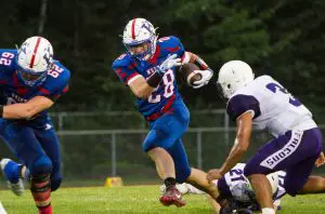 Keaton Rounsville (62) opens up running room for Erik DeLong of Kane in Friday night's game with Coudersport. Photo by Shawn Murray